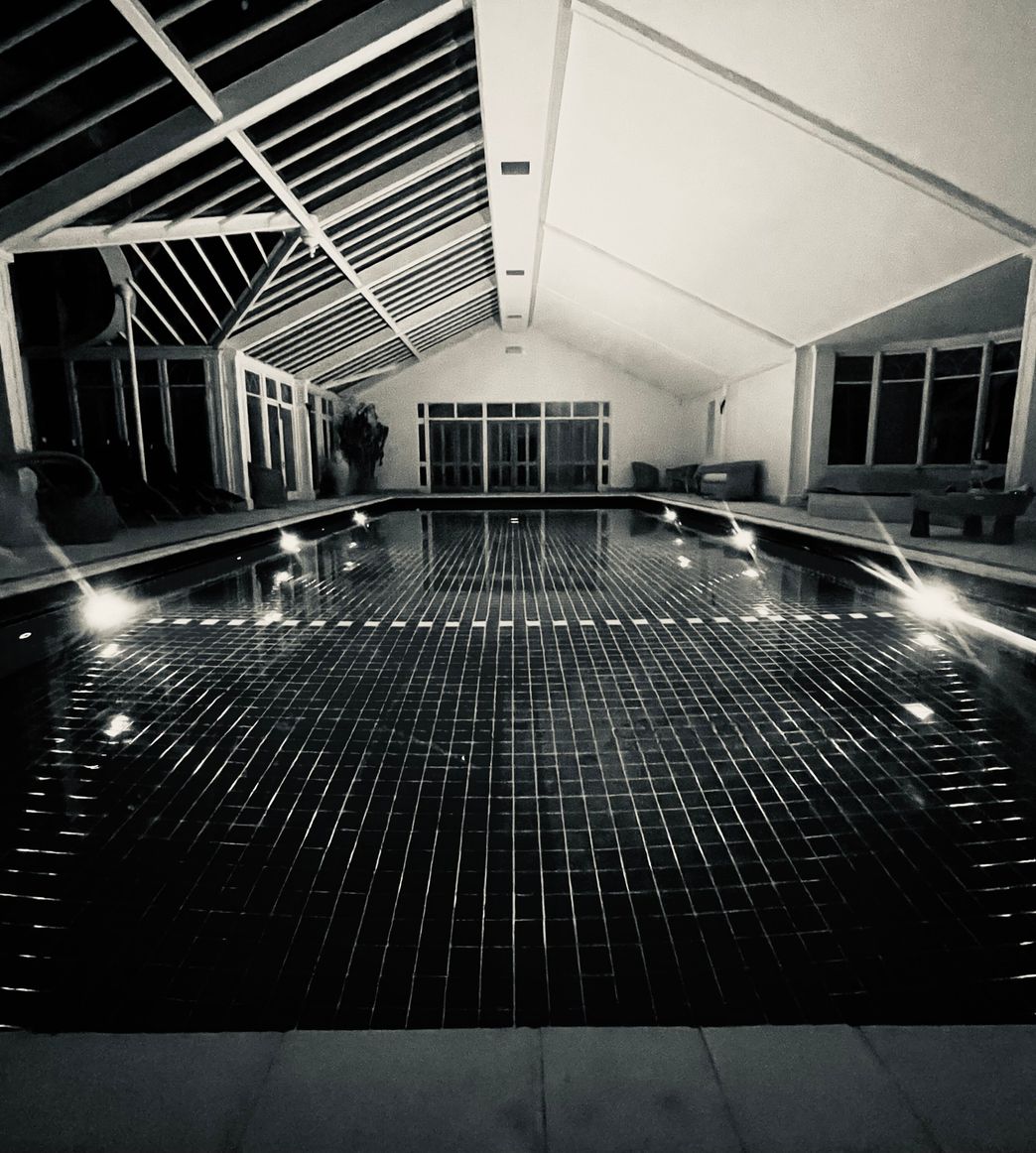 a pool cover wrapped up next to a blue pool