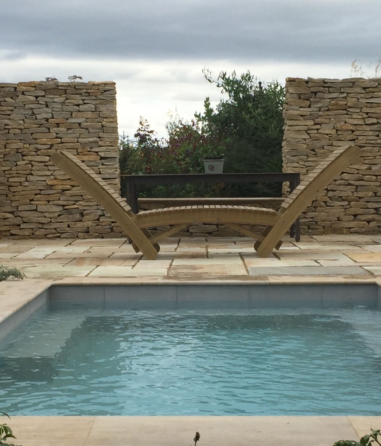 a garden ornament looks over a clean pool